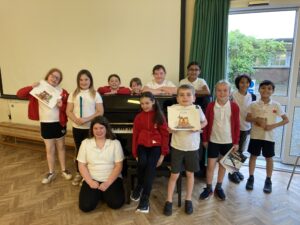 People around an upright piano